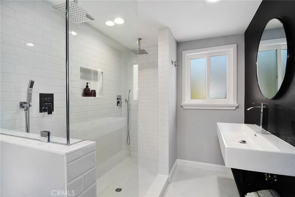 12427 Sunset Boulevard Los Angeles, CA 90049 - Photo 39 of 58 a bathroom with a sink a toilet and shower