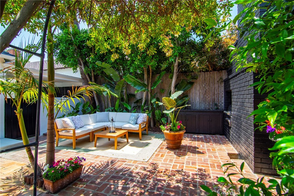 12427 Sunset Boulevard Los Angeles, CA 90049 - Photo 43 of 58 a view of a chair and tables in the backyard with potted plants