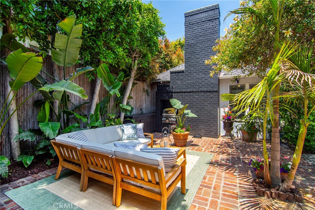 12427 Sunset Boulevard Los Angeles, CA 90049 - Photo 44 of 58 a view of a patio with table and chairs potted plants and large tree