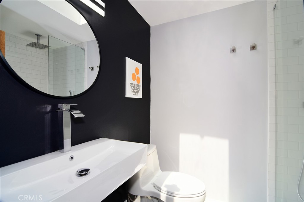 12427 Sunset Boulevard Los Angeles, CA 90049 - Photo 53 of 58 a bathroom with a sink toilet and mirror
