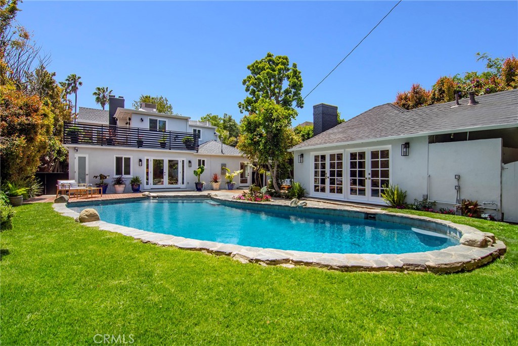 12427 Sunset Boulevard Los Angeles, CA 90049 - Photo 57 of 58 a view of swimming pool with outdoor seating and house in the background