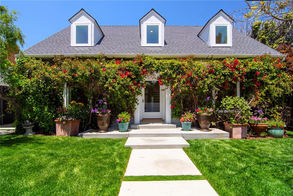 12427 Sunset Boulevard Los Angeles, CA 90049 - Photo 6 of 58 a front view of a house with a yard