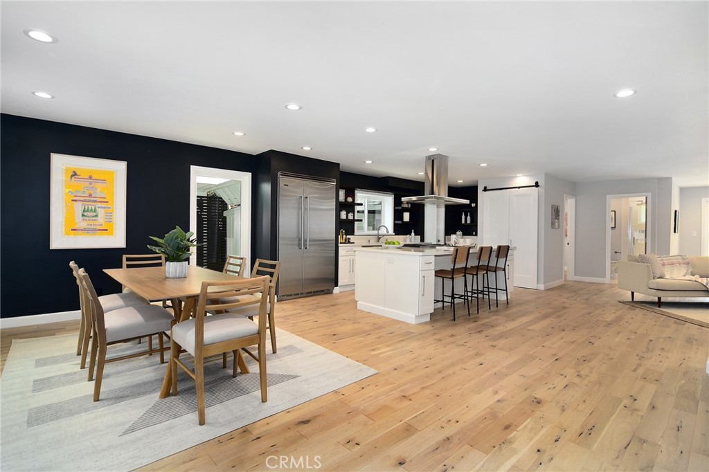 12427 Sunset Boulevard Los Angeles, CA 90049 - Photo 7 of 58 a living room with furniture a dining table and kitchen view
