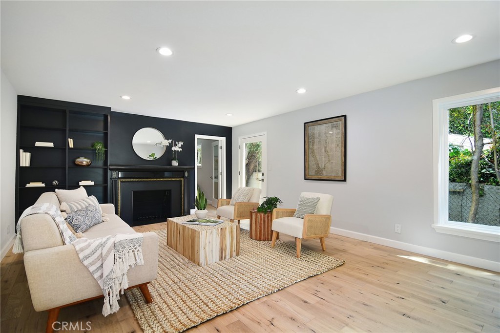 12427 Sunset Boulevard Los Angeles, CA 90049 - Photo 9 of 58 a living room with furniture a rug and a fireplace