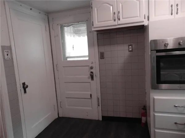 a bathroom with a granite countertop sink and cabinets