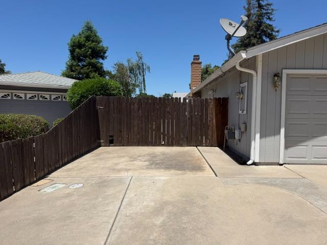 2601 Temperate Court Modesto, CA 95358 - Photo 4 of 24 a house with a yard and wooden fence