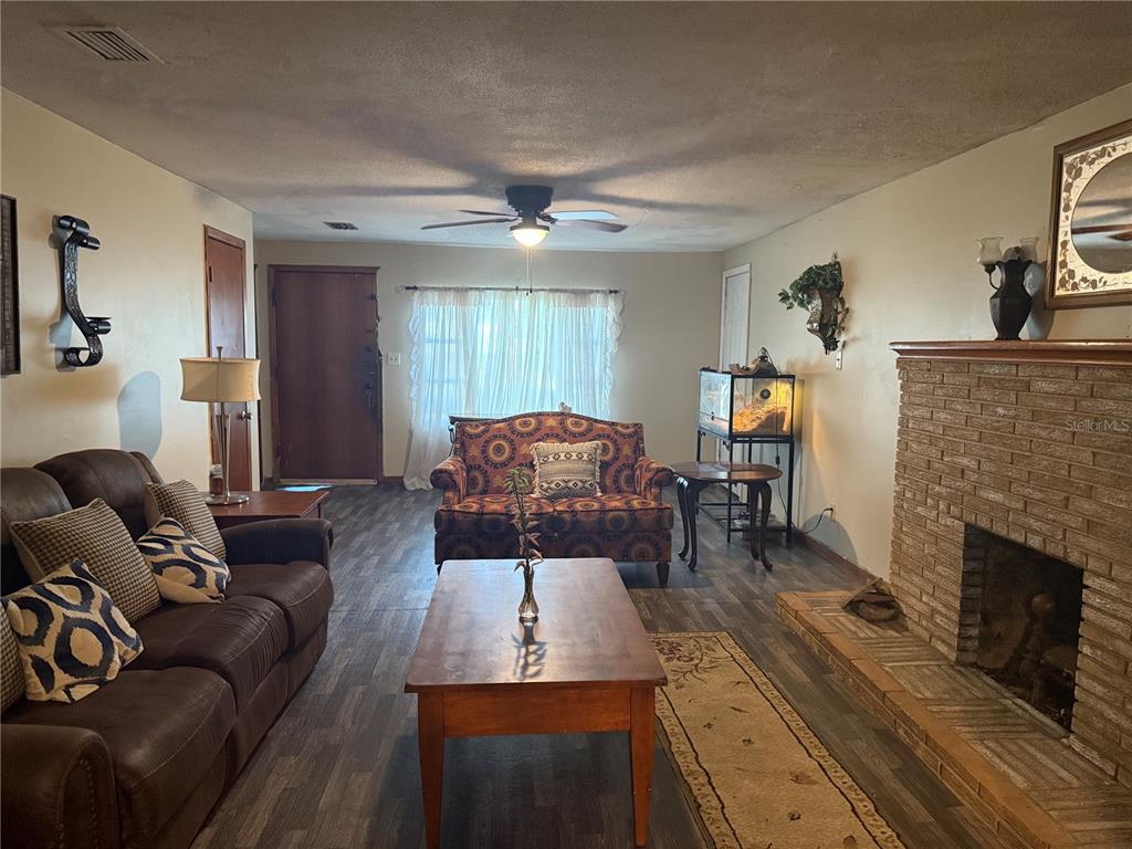 3011 South Wiggins Road Plant City, FL 33566 - Photo 7 of 17 a living room with furniture and a fireplace