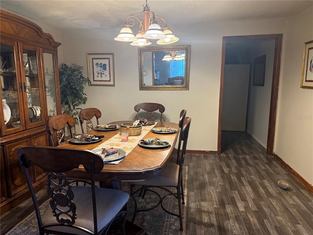 3011 South Wiggins Road Plant City, FL 33566 - Photo 9 of 17 a view of a dining room with furniture and chandelier