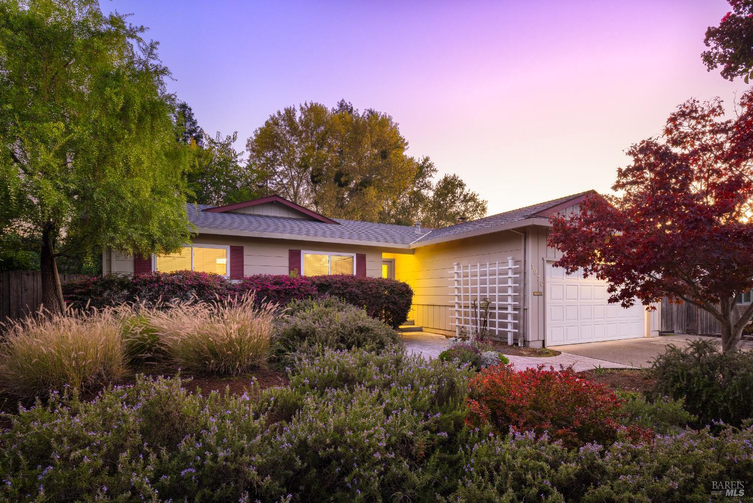 a view of a house with a yard and tree s