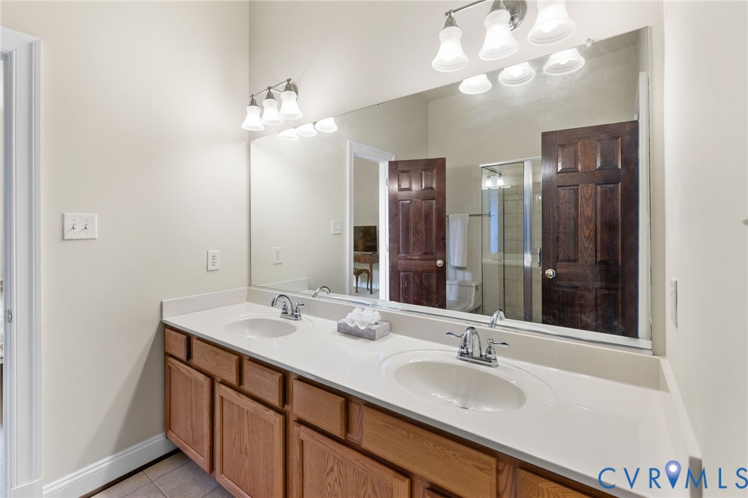 13173 Scotchtown Road Beaverdam, VA 23015 - Photo 48 of 65 a bathroom with a double vanity sink and a mirror