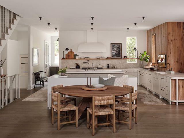 a kitchen with a dining table chairs and window