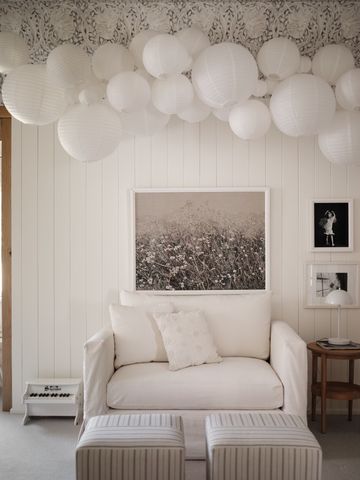 a bedroom with furniture and a large window