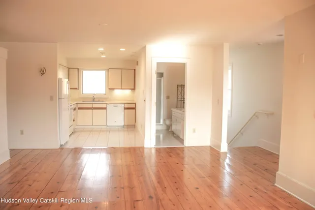 a kitchen with white cabinets and refrigerator