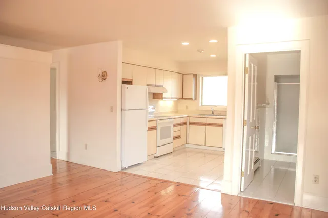a kitchen with white cabinets and white appliances