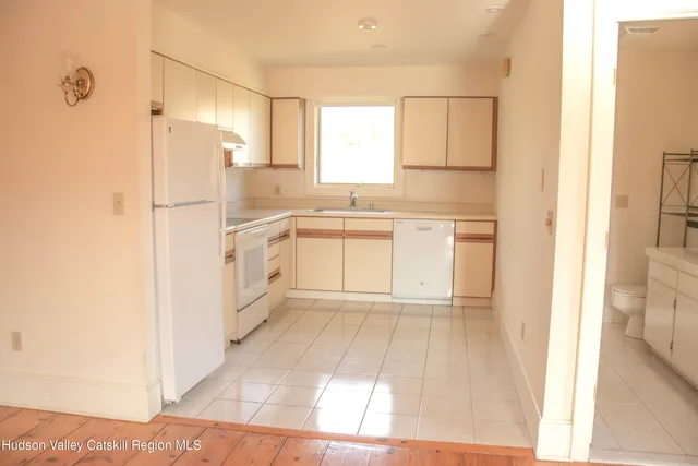 a view of a kitchen with wooden floor