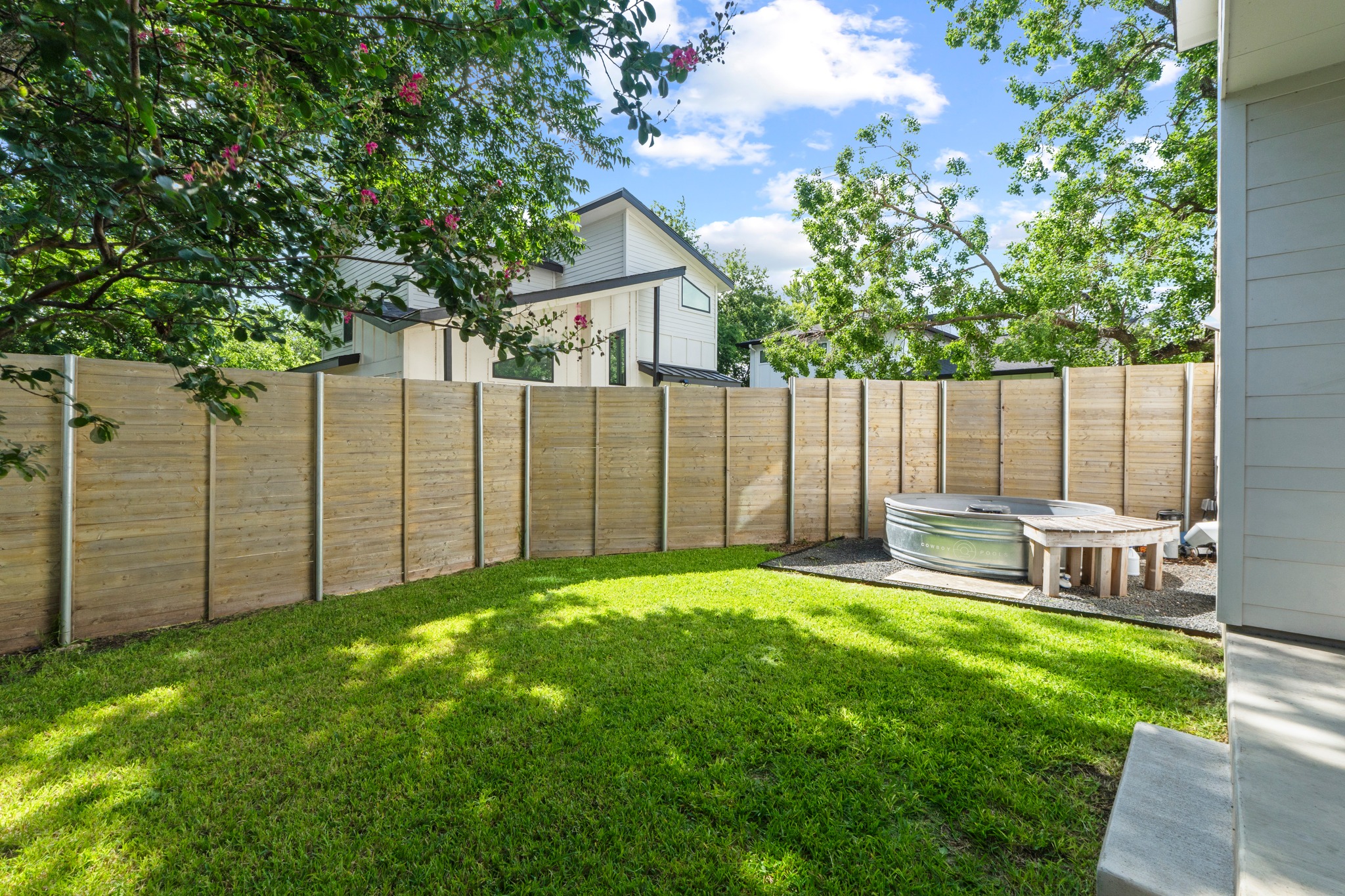 2007 Chestnut Avenue, Unit 1 Austin, TX 78722 - Photo 31 of 32 A tranquil yard features a wood privacy fence and a refreshing spa.