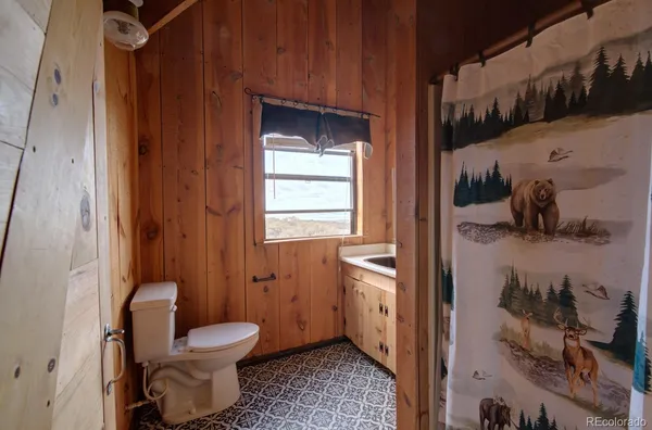 a bathroom with a toilet a sink and a window