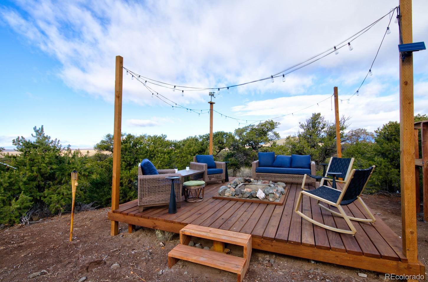 1159 Pfotenhauer Road Fort Garland, CO 81133 - Photo 33 of 46 a view of a patio with table and chairs potted plants with wooden floor