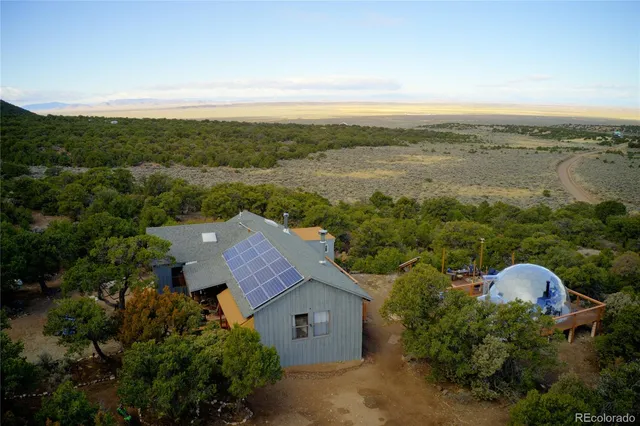 an aerial view of a house with pool
