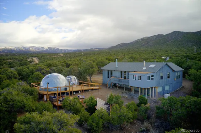 a view of a lush green hillside and a houses