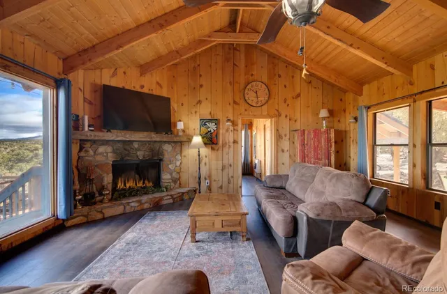 a living room with furniture a flat screen tv and a fireplace