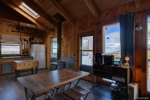a dining room with furniture and wooden floor