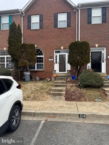 a car parked in front of white house