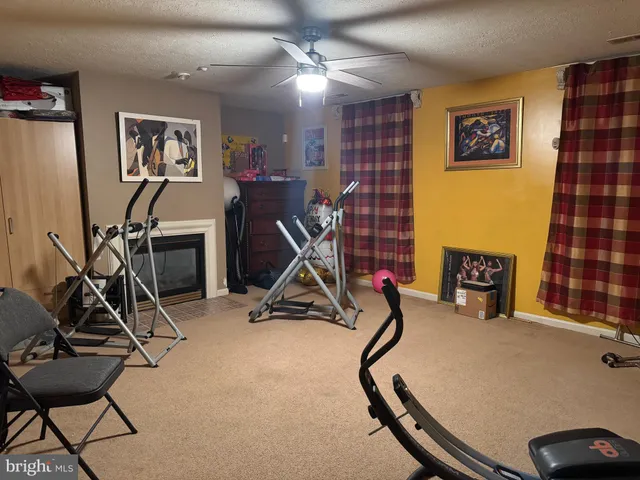 a room with gym equipment and windows