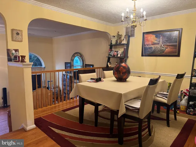 a view of a dining room with furniture and chandelier