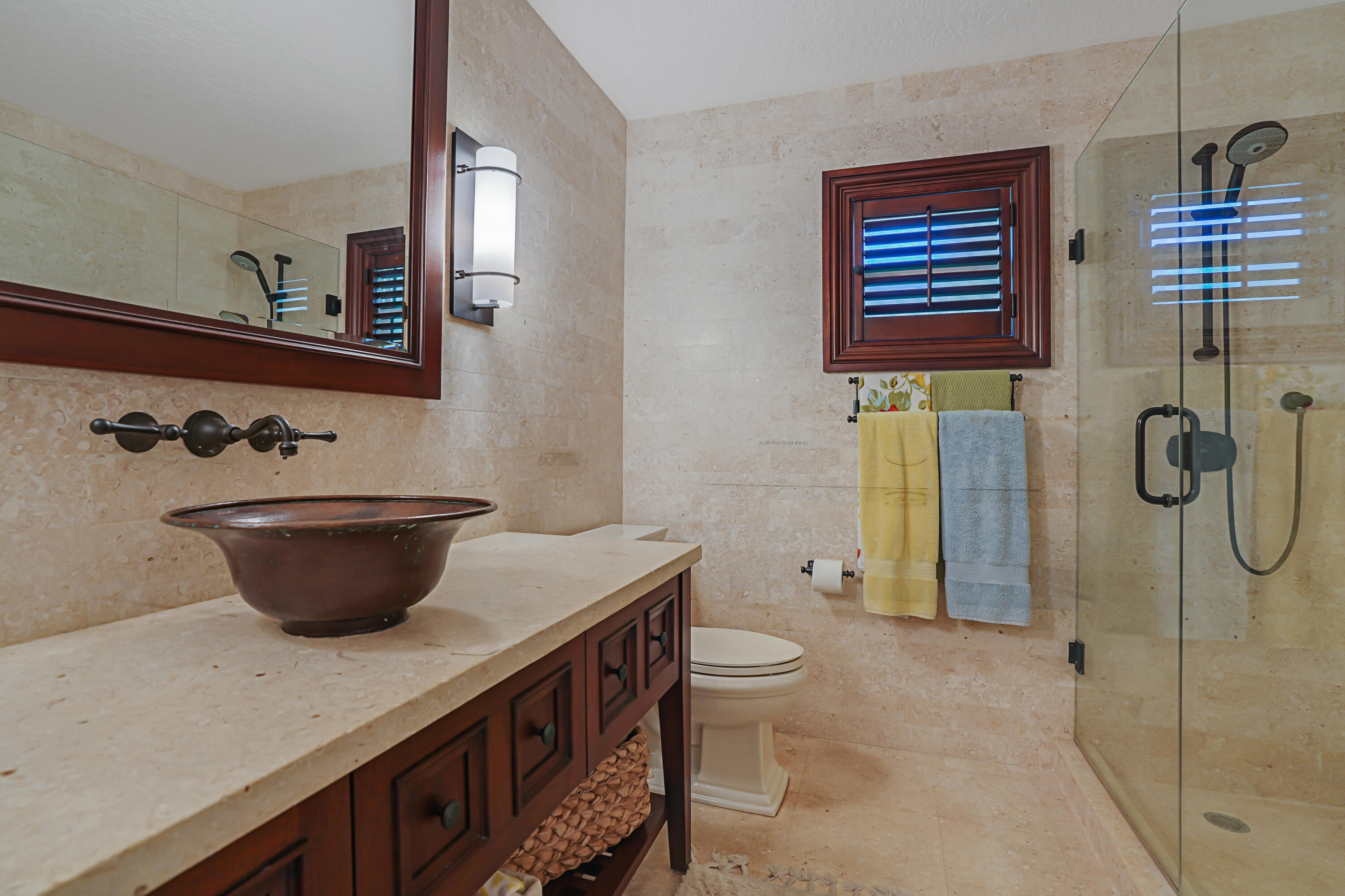 6000 Eagles Nest Drive Jupiter, FL 33458 - Photo 31 of 86 a bathroom with a toilet sink and shower