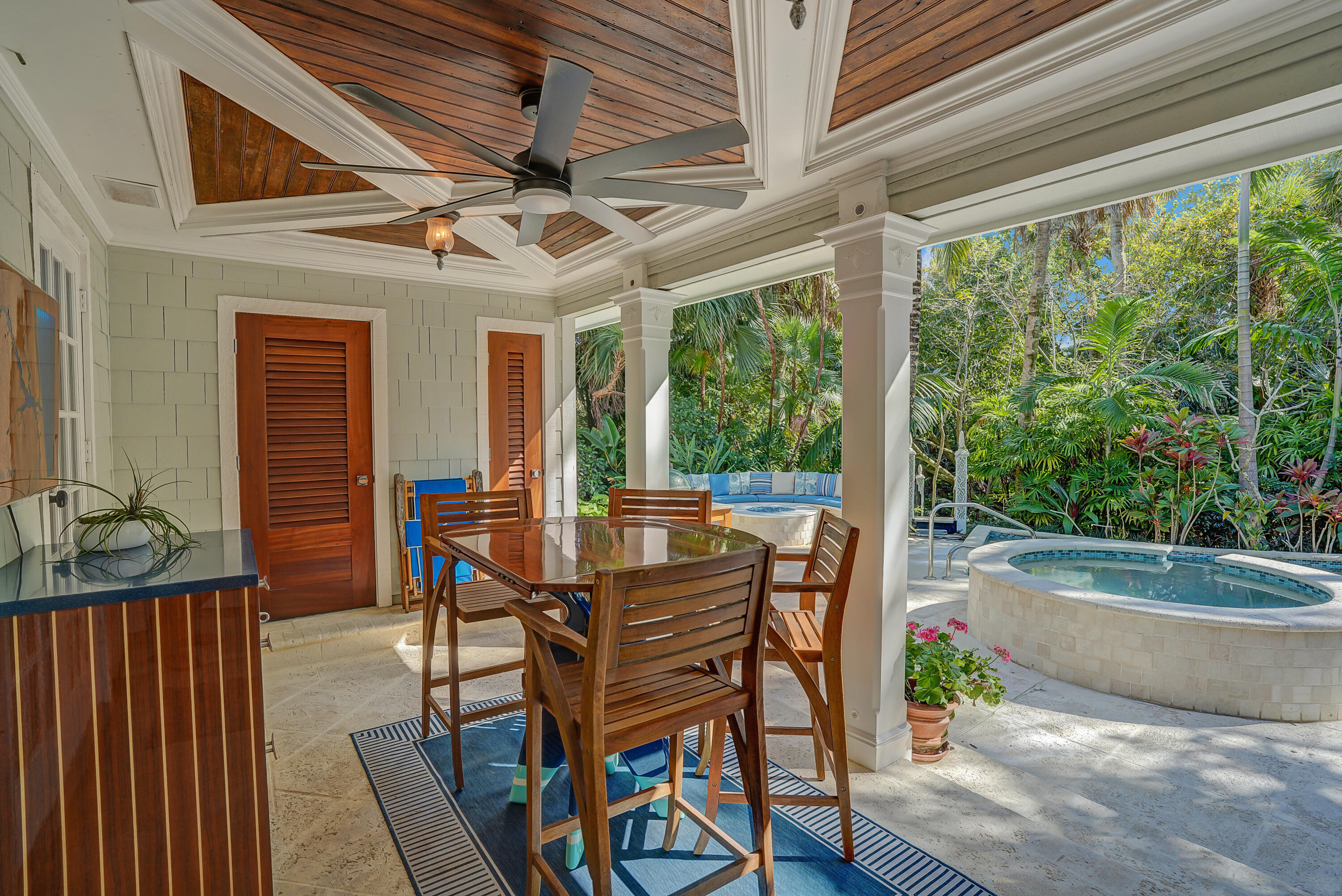 6000 Eagles Nest Drive Jupiter, FL 33458 - Photo 35 of 86 a view of a patio with table and chairs and wooden floor