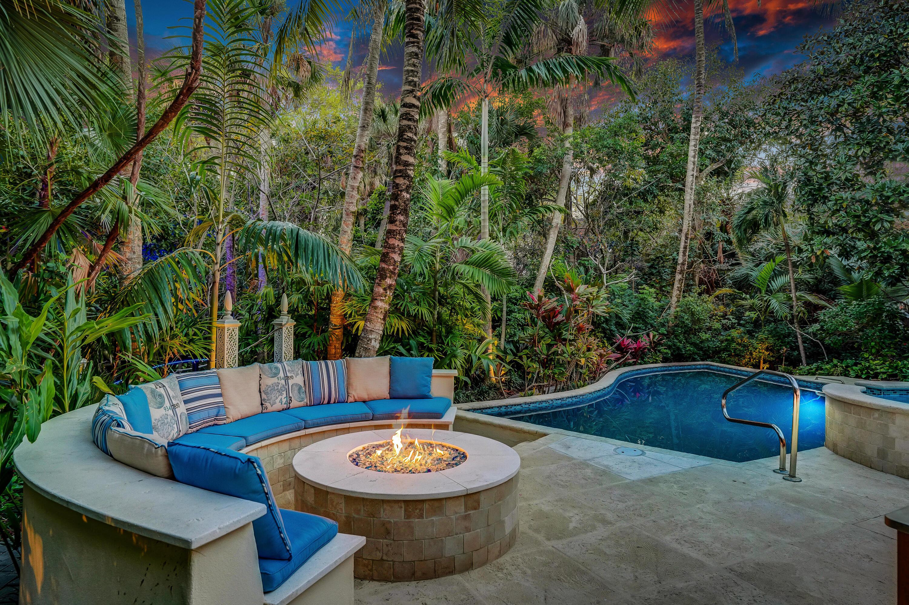 6000 Eagles Nest Drive Jupiter, FL 33458 - Photo 45 of 86 a backyard of a house with fire pit and outdoor seating