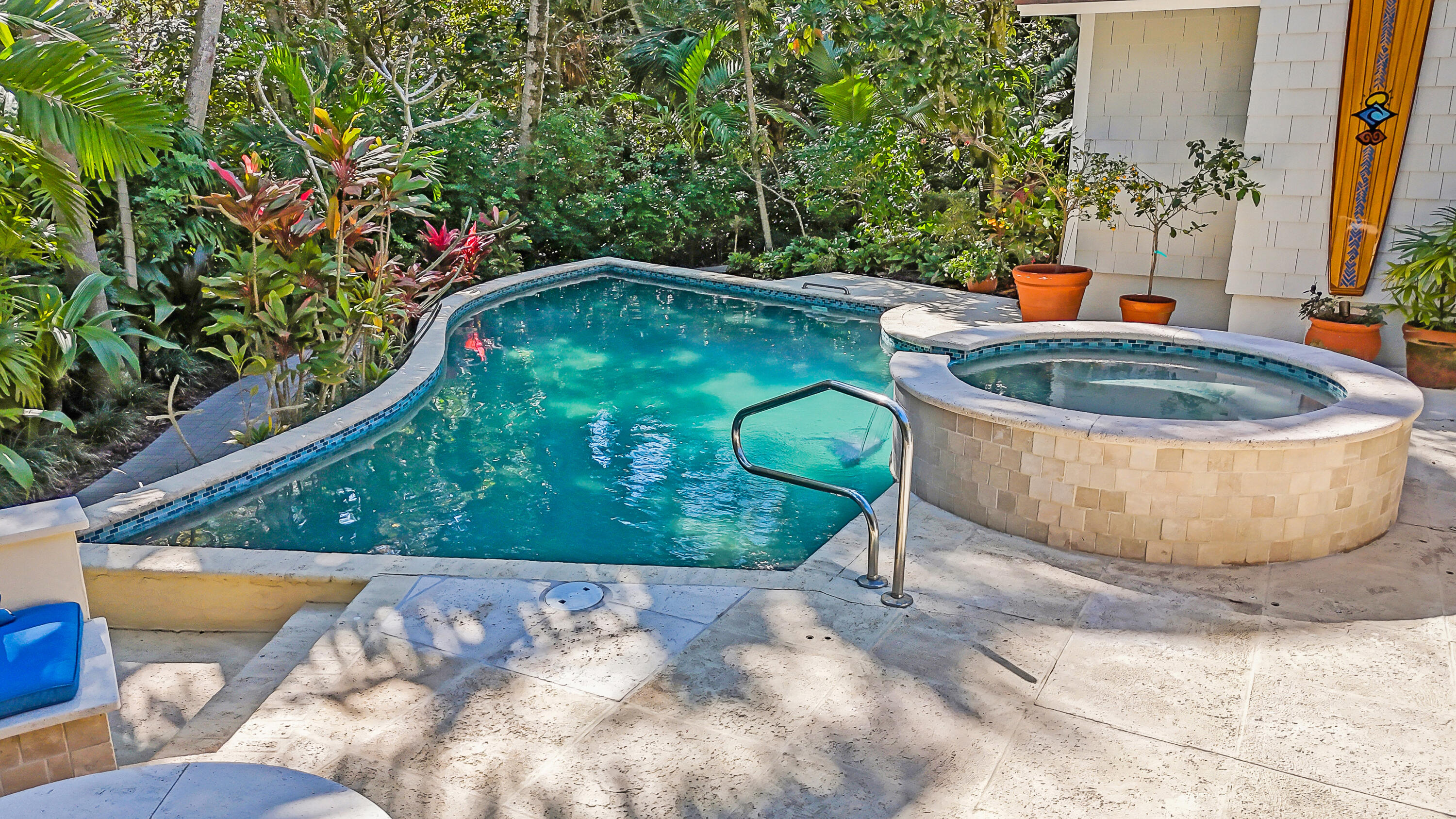6000 Eagles Nest Drive Jupiter, FL 33458 - Photo 62 of 86 a view of a swimming pool with a patio and plants