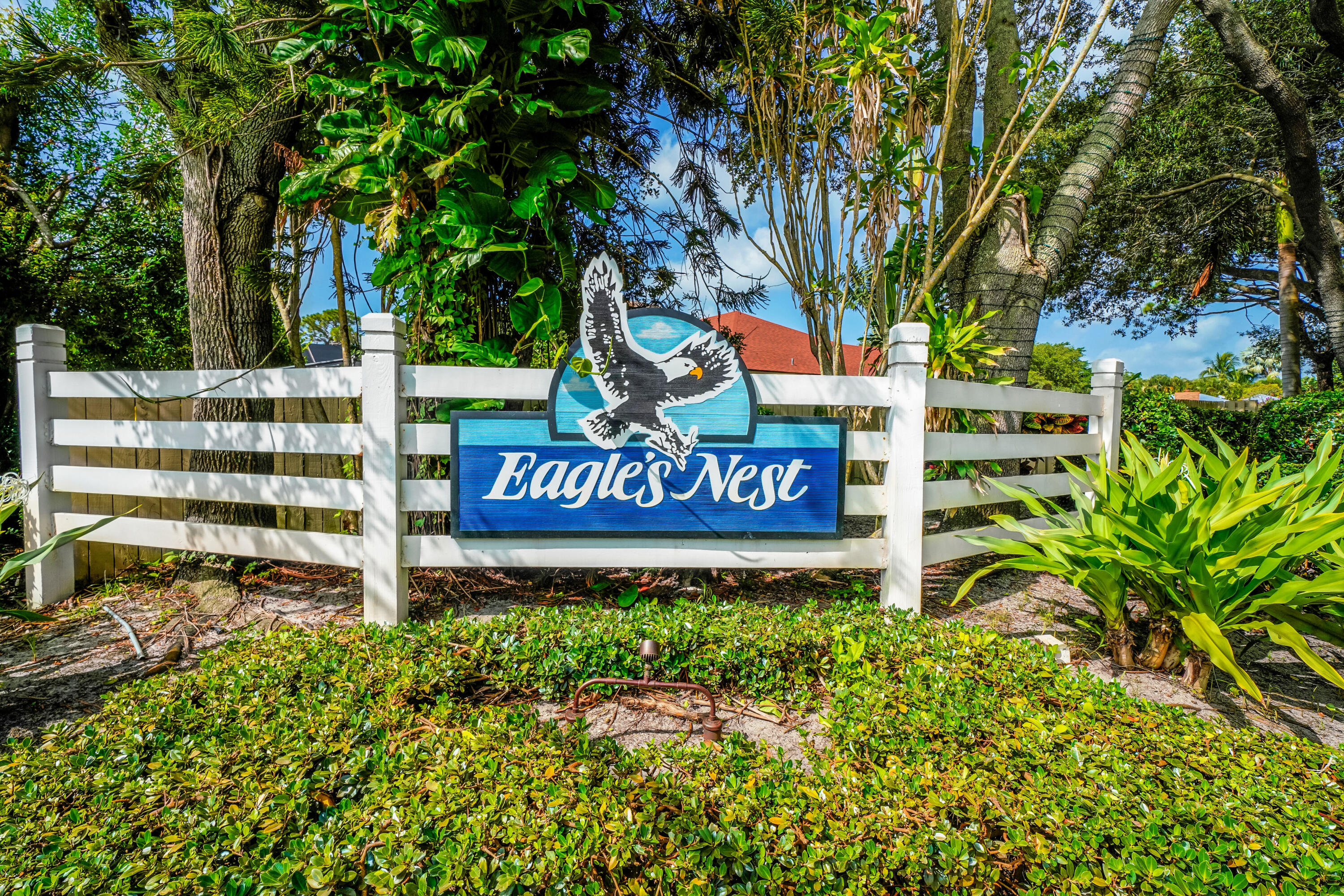 6000 Eagles Nest Drive Jupiter, FL 33458 - Photo 79 of 86 a sign that is sitting in front of a tree