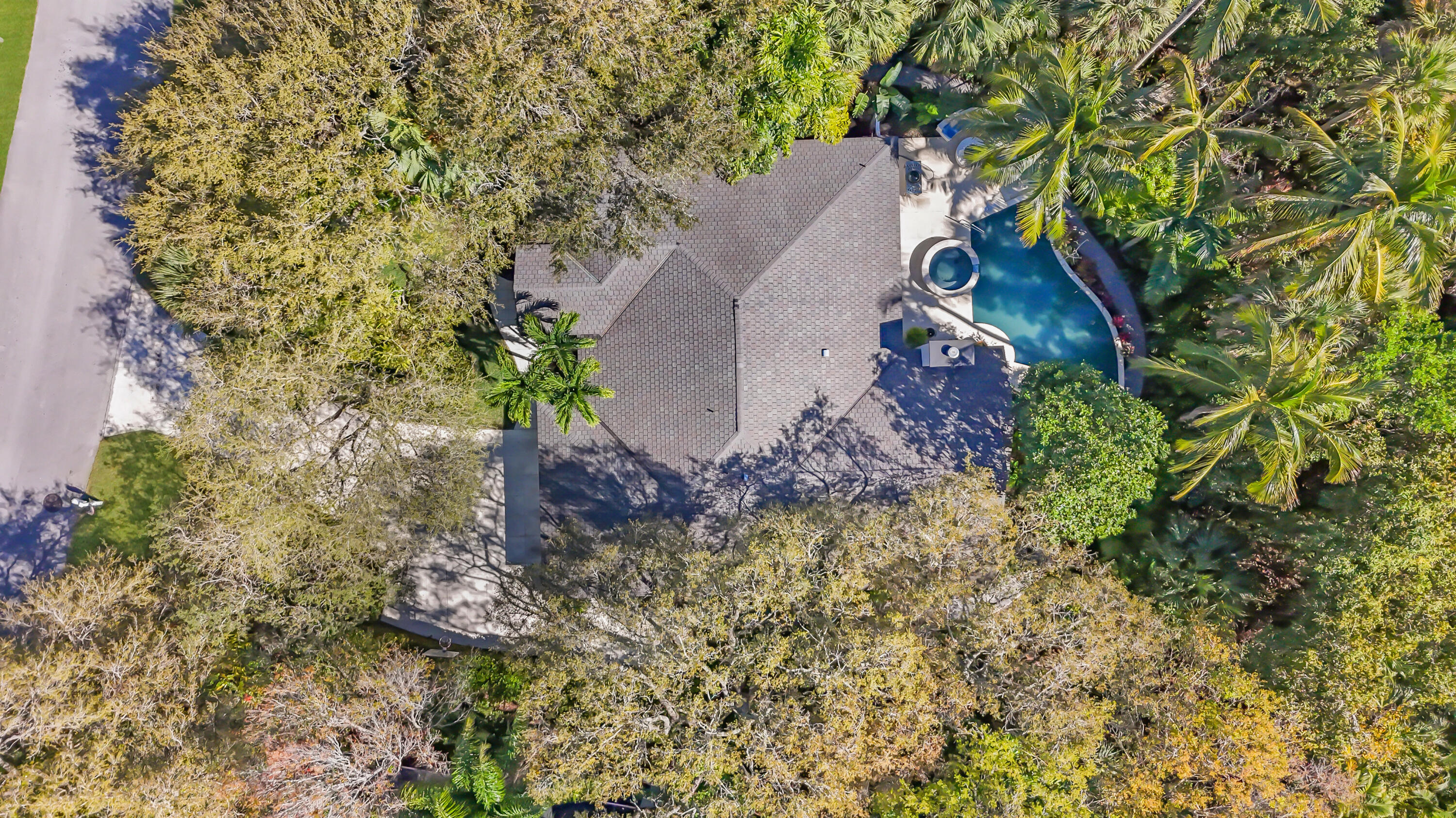 6000 Eagles Nest Drive Jupiter, FL 33458 - Photo 82 of 86 an aerial view of a house with a yard and large tree