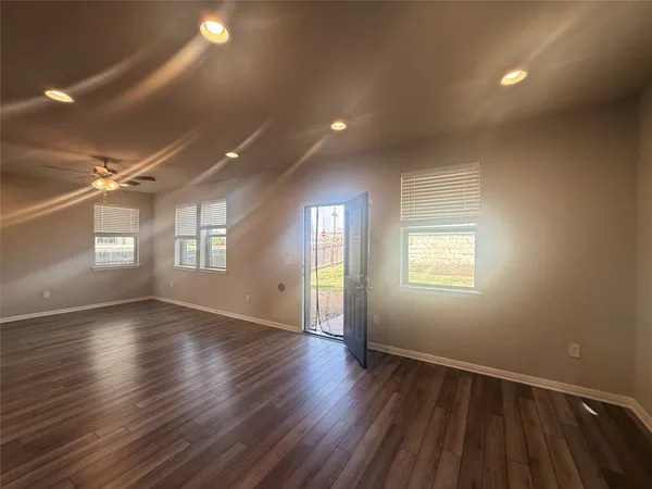 a view of kitchen with refrigerator microwave and cabinets