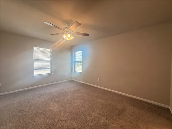 a view of staircase with lots of frames on wall and wooden floor