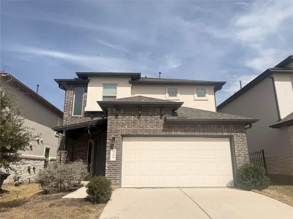 a front view of a house with a large window