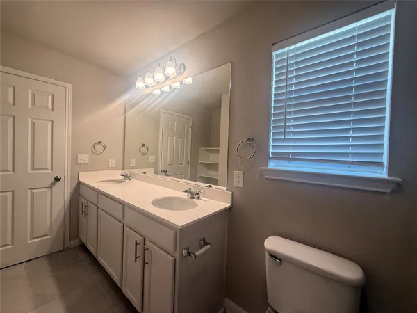 a bathroom with a sink double vanity granite tub and shower