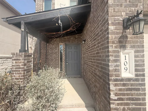 a view of a kitchen with granite countertop wooden floor stainless steel appliances and a chandelier