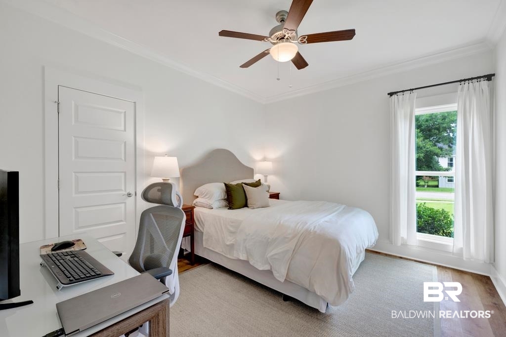 379 Pecan Ridge Boulevard Fairhope, AL 36532 - Photo 15 of 21 Bright room featuring wood-finish flooring, a multi-pane window, and a ceiling fan with integrated lighting