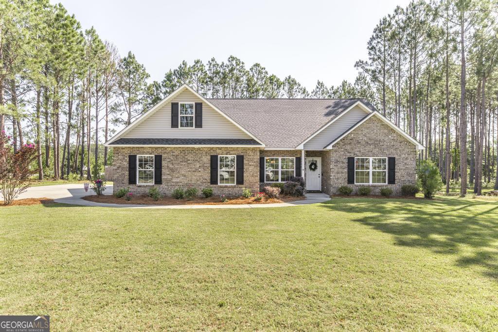609 Live Oak Way Dublin, GA 31021 - Photo 1 of 37 a front view of a house with swimming pool having outdoor seating