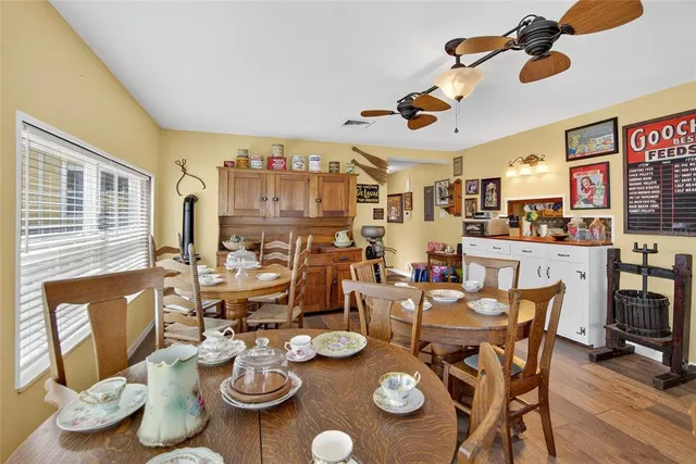 a dining room with furniture and wooden floor