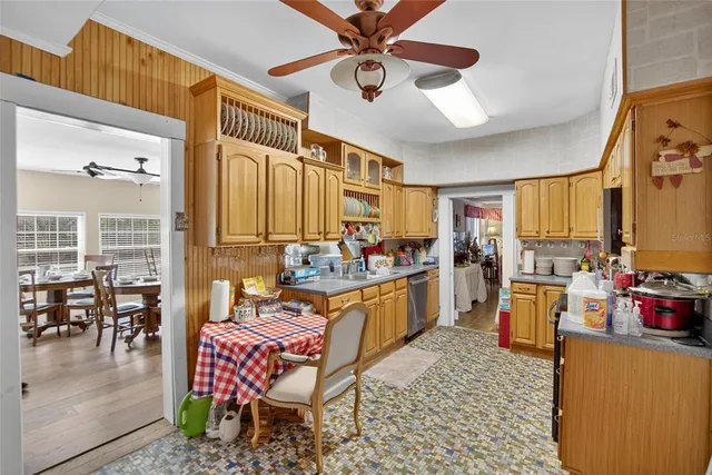 a bedroom with a bed a couch and a flat tv screen on dresser