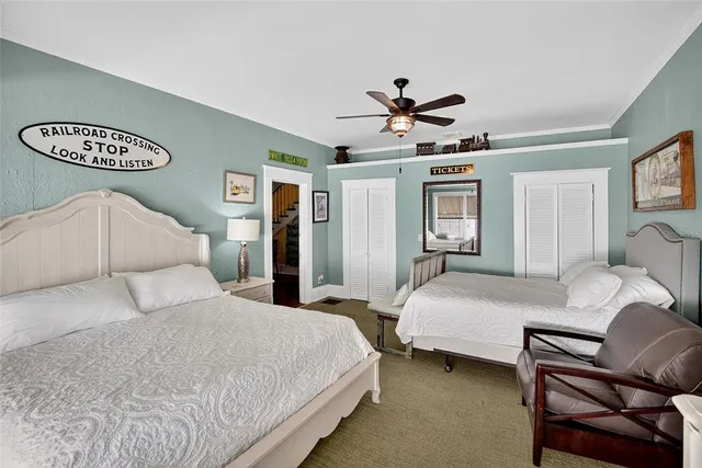 a bathroom with a granite countertop sink a toilet and a mirror