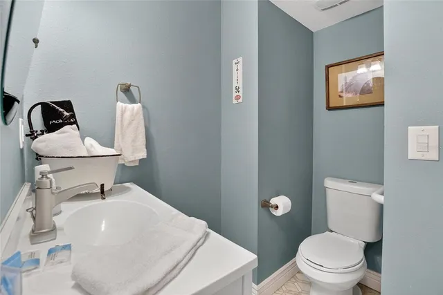 a bedroom with two beds and a painting on the wall