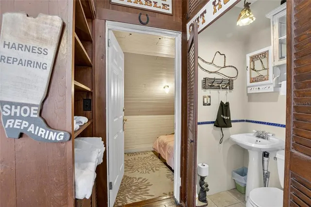 a backyard of a house with table and chairs under an umbrella
