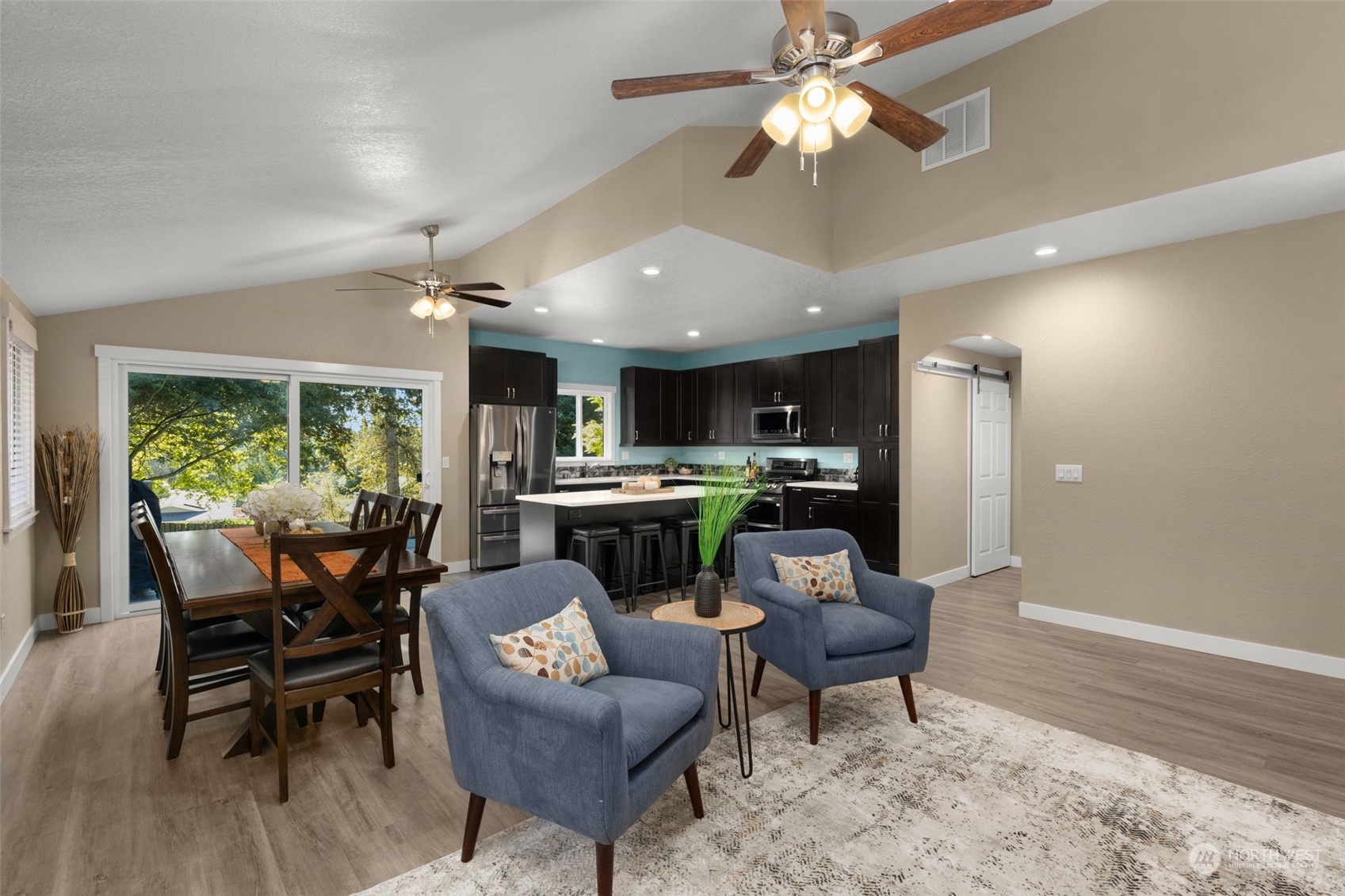 17547 Southeast 135th Street Renton, WA 98059 - Photo 12 of 37 a living room with furniture a dining table with kitchen view and a chandelier