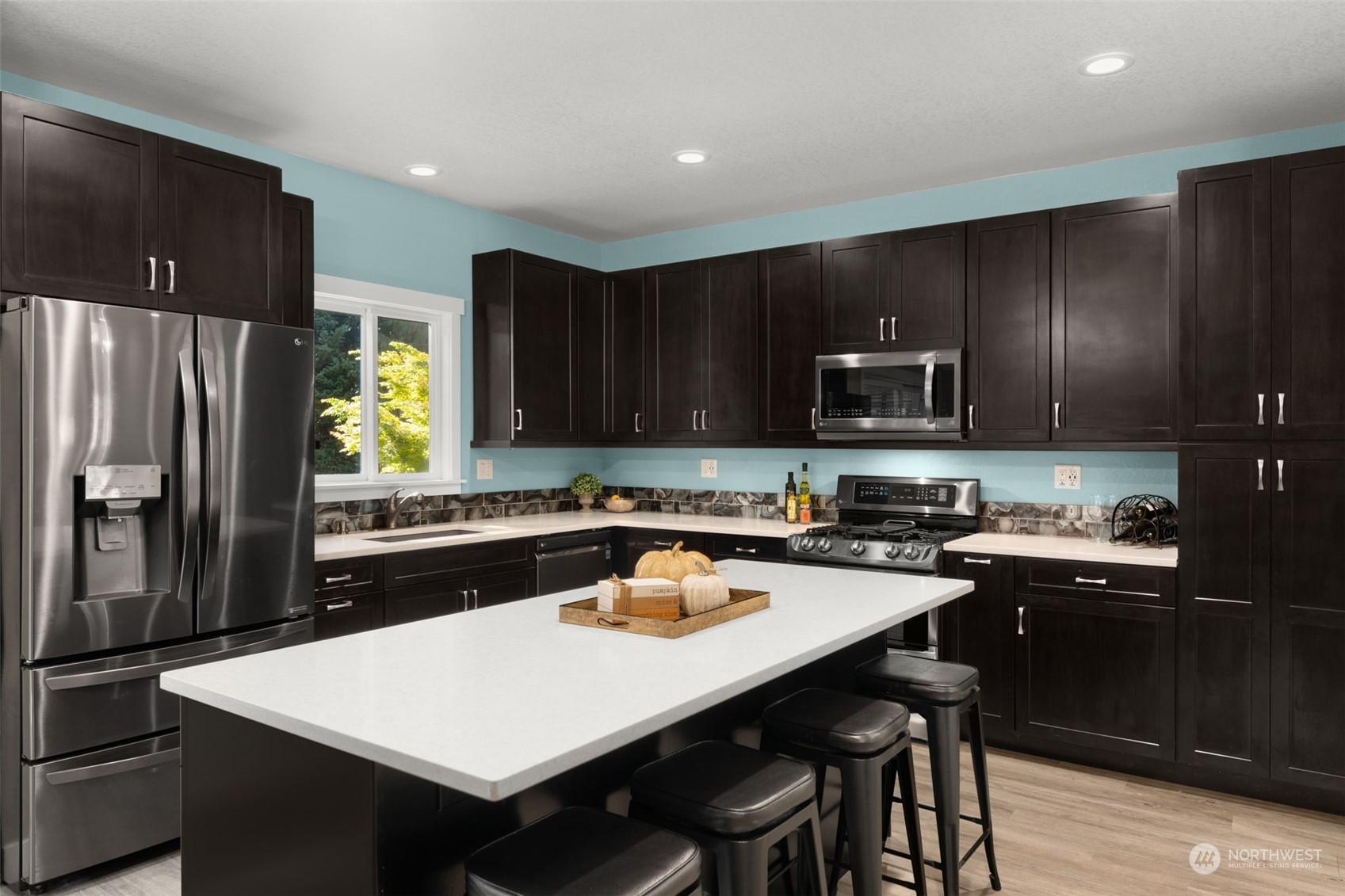 17547 Southeast 135th Street Renton, WA 98059 - Photo 15 of 37 a kitchen with a sink a stove a refrigerator a center island and chairs