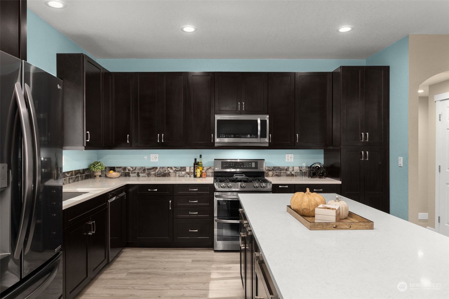 17547 Southeast 135th Street Renton, WA 98059 - Photo 16 of 37 a kitchen with a sink a stove top oven and wooden floor